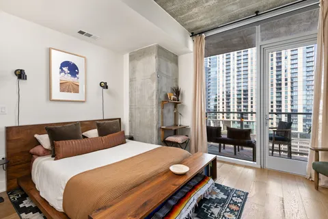 a bedroom with a bed and a window