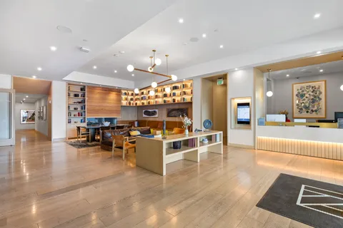 a view of a living room kitchen with stainless steel appliances