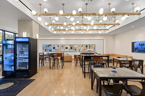 a view of a dining room with furniture and chandelier