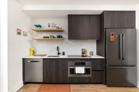 a kitchen with stainless steel appliances a sink and a refrigerator