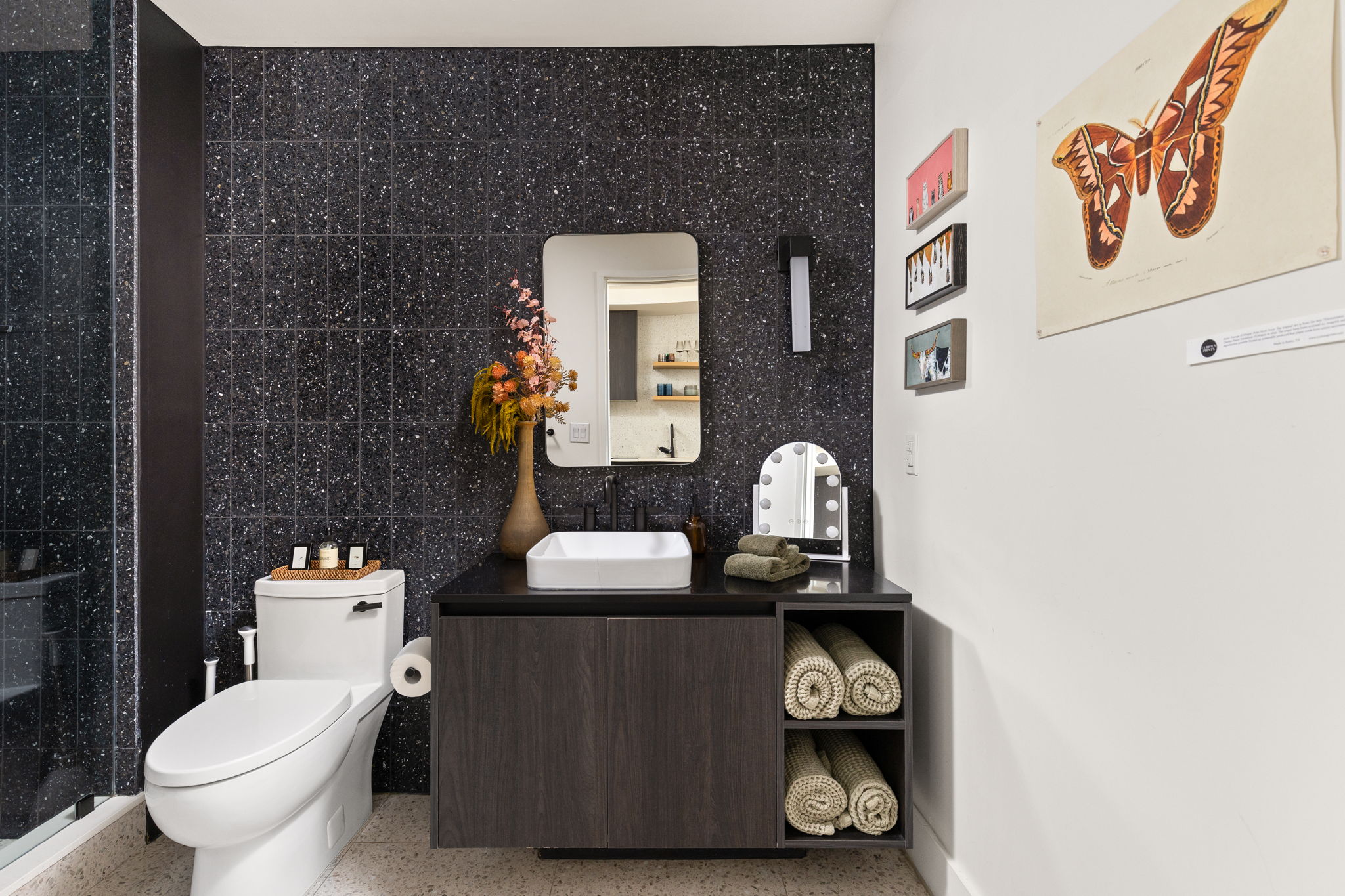 48 East Avenue, Unit 2002 Austin, TX 78701 - Photo 8 of 38 Bathroom featuring speckle patterned floor, vanity, tile walls, and a stall shower