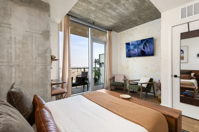 a bedroom with a bed a table and chair