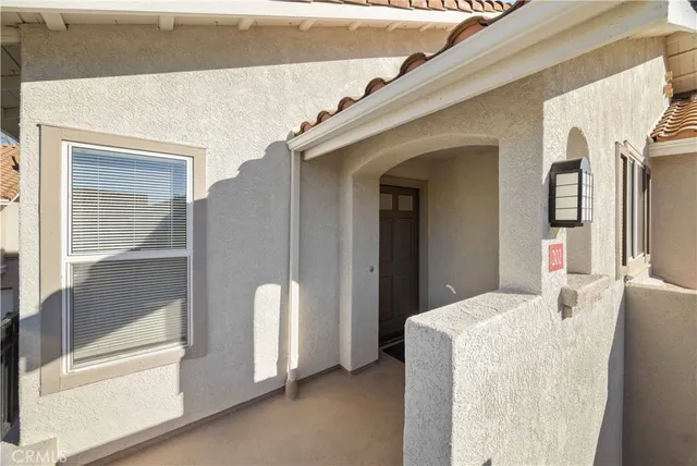 a bedroom with furniture and large windows