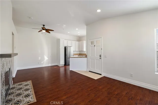a view of a kitchen with a sink and a refrigerator