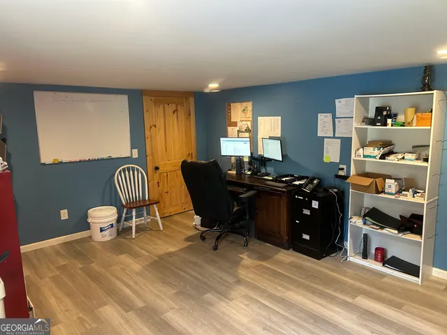 a view of a green field with wooden fence