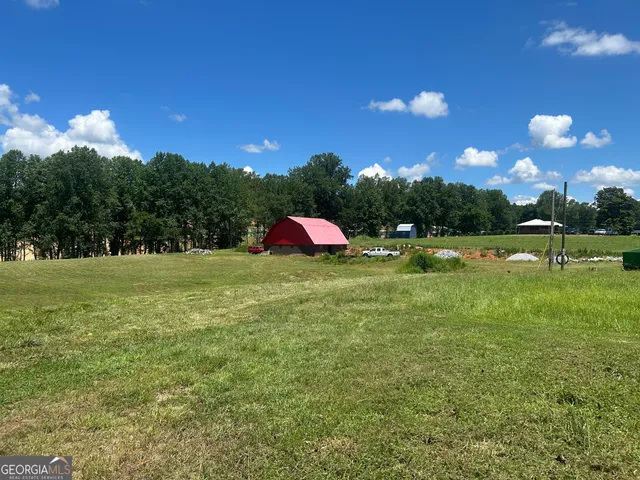 a view of a house with a yard and sitting area