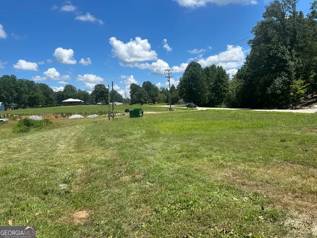 a view of a patio with a table and chairs under an umbrella