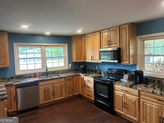 a kitchen with a refrigerator and a stove top oven