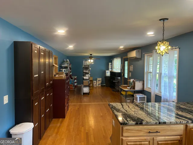 a kitchen with stainless steel appliances granite countertop a sink a stove and a refrigerator