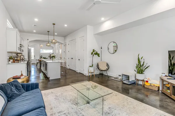 a living room with furniture and kitchen view