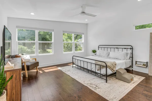 a bedroom with a bed and a large window