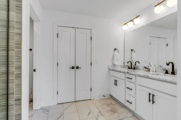 a bathroom with a double vanity sink and mirror