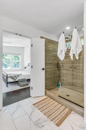 a bathroom with a sink a mirror and shower