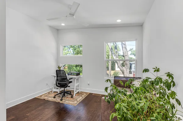 a living room with furniture and a potted plant