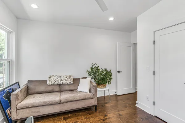 a living room with furniture and a potted plant