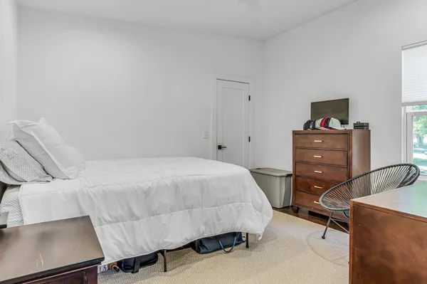 a bedroom with a bed and a desk