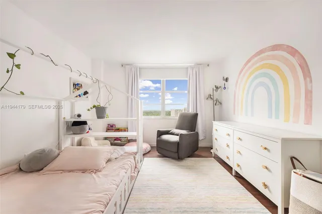 a bedroom with furniture and a large window