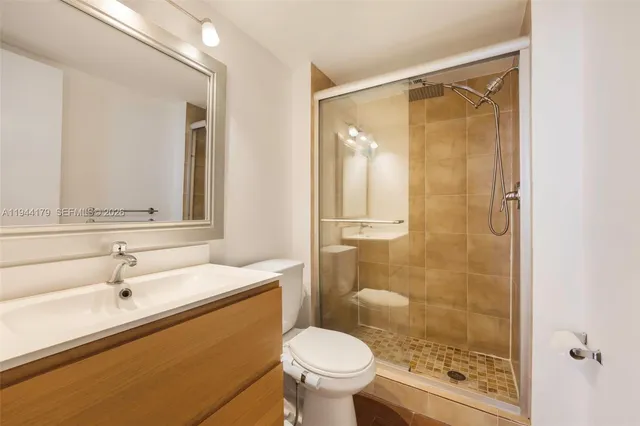 a bathroom with a sink toilet and shower