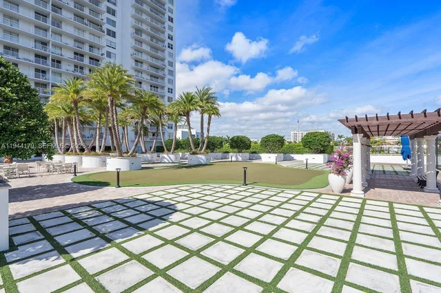 a swimming pool with outdoor seating and yard