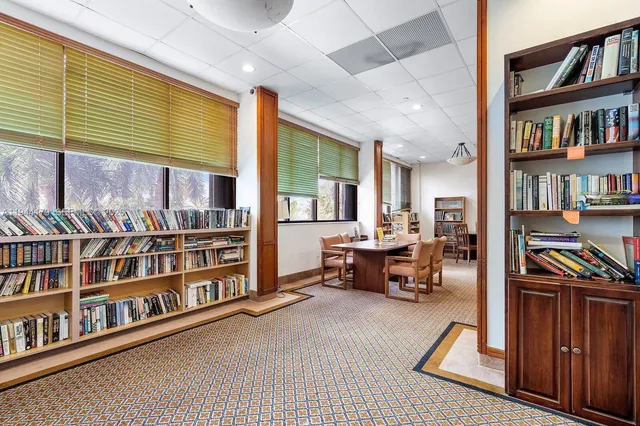a living room with lots of furniture and a book shelf