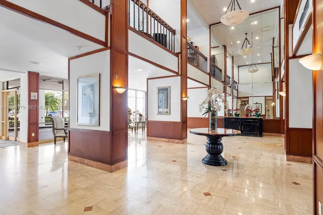 a view of entryway with a floor to ceiling window and a kitchen view
