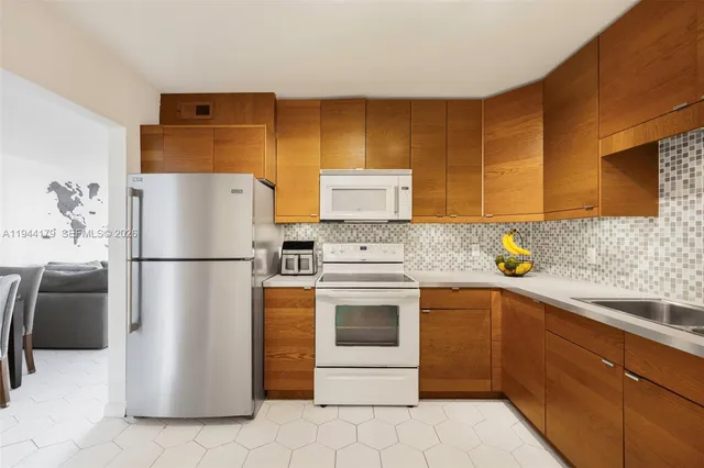 a kitchen with a refrigerator sink and stove