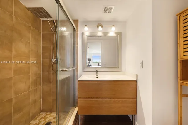 a bathroom with a mirror and a shower