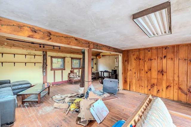 a living room with furniture a rug and a window
