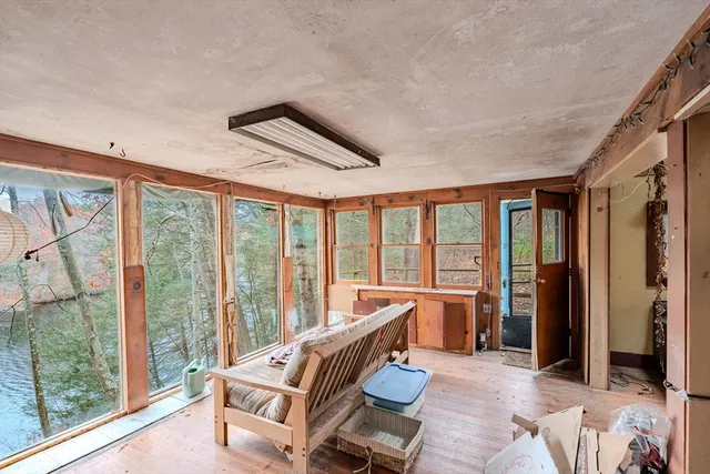 a living room with furniture and a floor to ceiling window