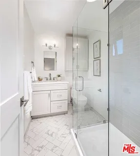 a bathroom with a sink toilet a mirror and vanity