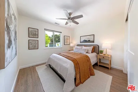 a bedroom with a large bed and a window