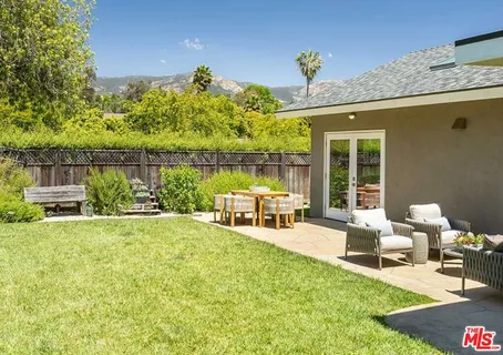 a view of a chair and tables in the patio