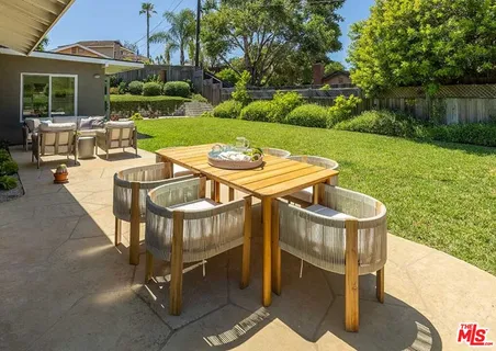 a view of an outdoor sitting area with furniture