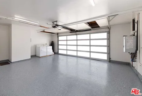 a view of empty room with windows and ceiling fan