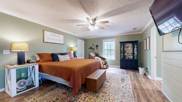 a bedroom with a bed and a chandelier