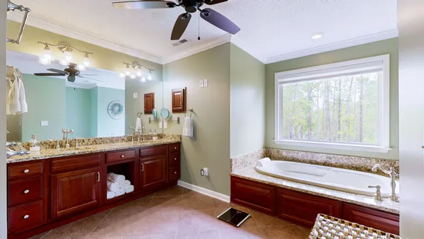 a spacious bathroom with a granite countertop tub sink and mirror