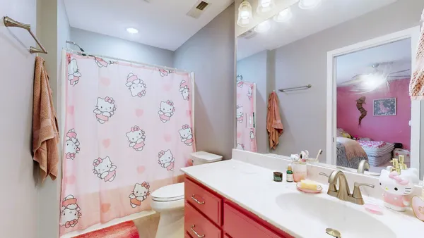 a bathroom with a sink vanity mirror and a toilet