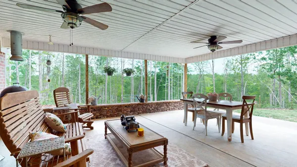 a view of a patio with a dining table and chairs