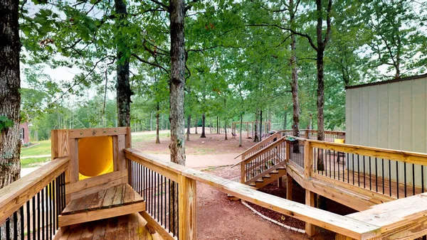 a view of balcony with wooden floor and fence