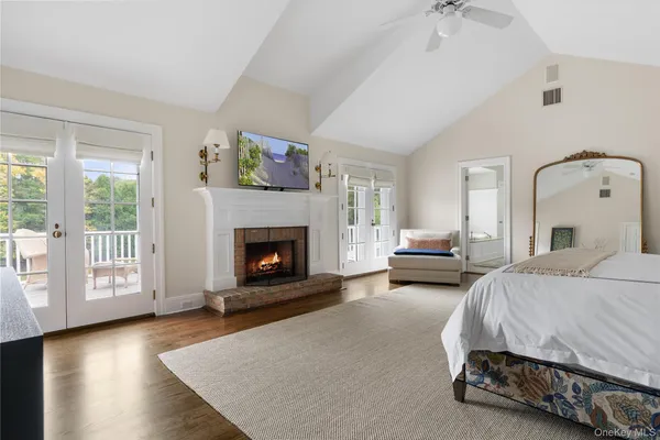 a spacious bedroom with a bed and a fireplace