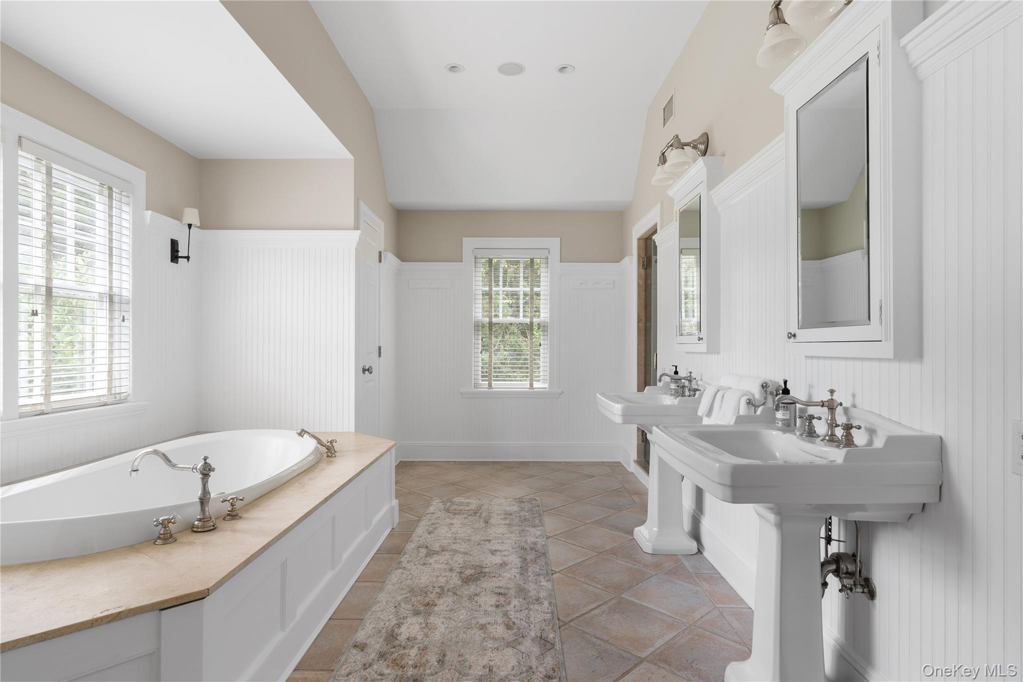 327 Georgica Road East Hampton, NY 11937 - Photo 17 of 36 a spacious bathroom with sinks mirror and a bathtub