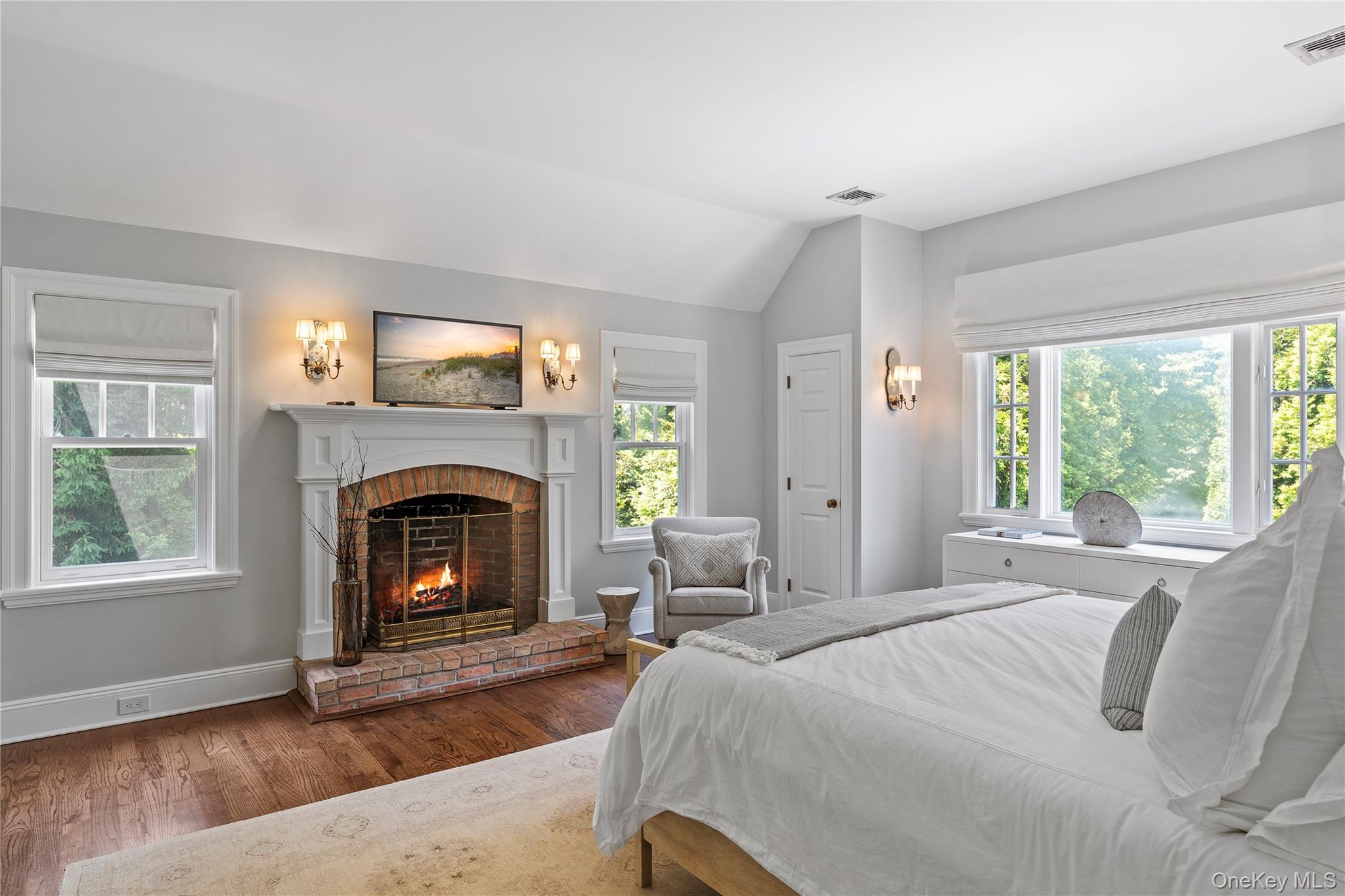 327 Georgica Road East Hampton, NY 11937 - Photo 19 of 36 a bedroom with a bed and a fireplace
