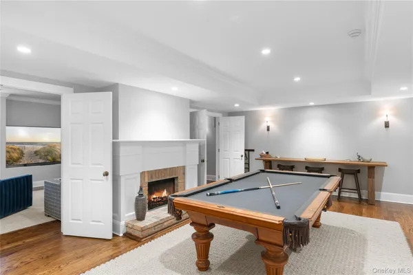 a room with furniture pool table and a fireplace