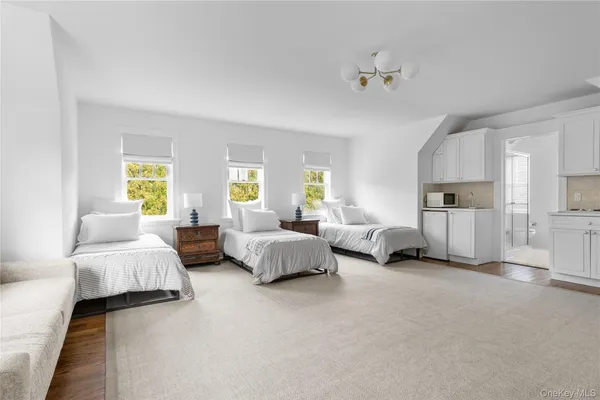 a spacious bedroom with a bed and couch