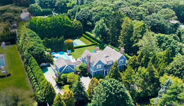 an aerial view of a house with a yard and garden