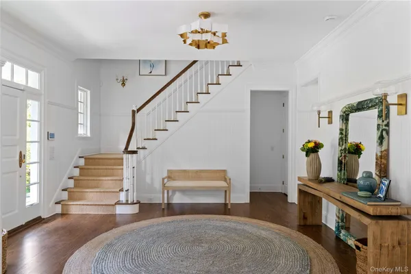 a living room with furniture and a stairs