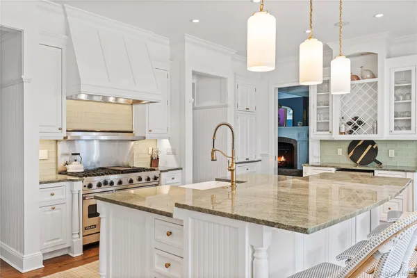 a kitchen with kitchen island granite countertop a sink a counter and cabinets
