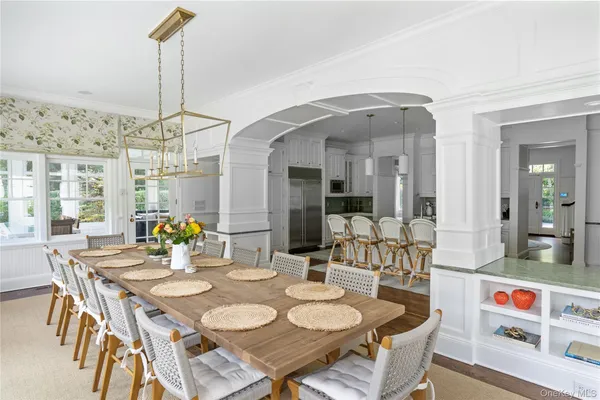 a outdoor dining area with furniture and a chandelier