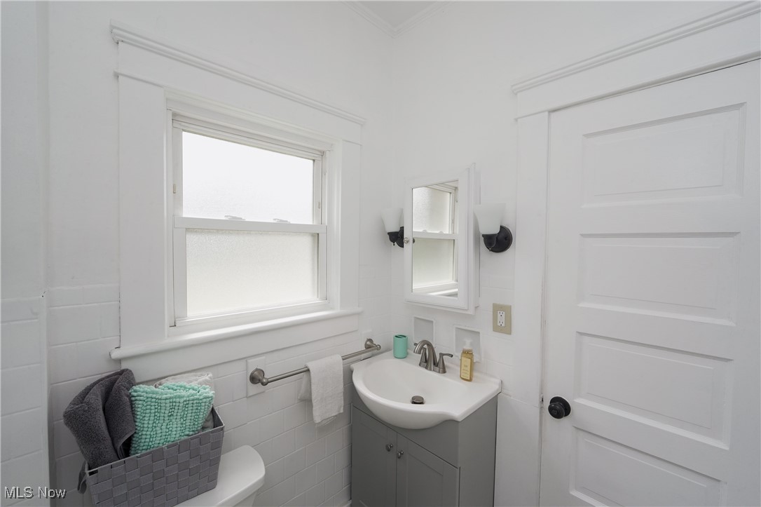 3542 Copley Road Akron, OH 44321 - Photo 21 of 47 Bathroom with tile walls, vanity, and toilet