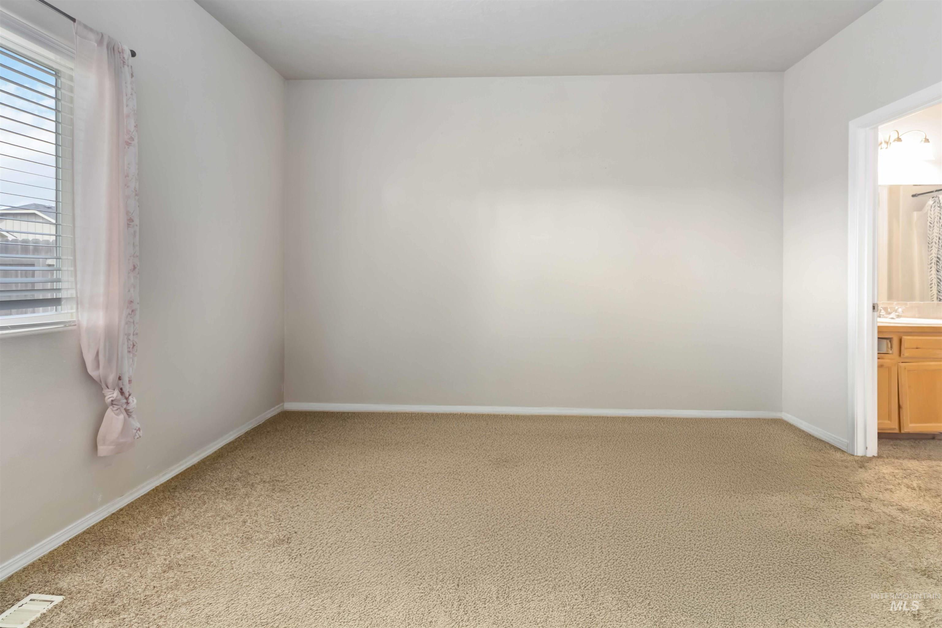 16053 Sunnyfield Avenue Caldwell, ID 83607 - Photo 16 of 35 Spare room with light carpet and baseboards